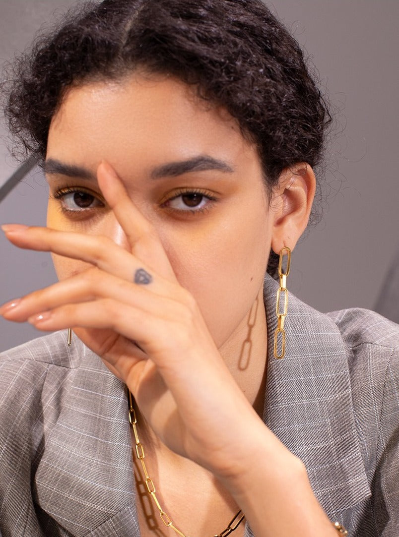 edgy girl with chain earrings and necklace