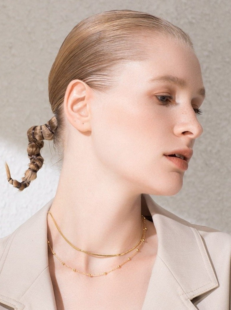 Elegant Woman wearing Blazer and Necklace